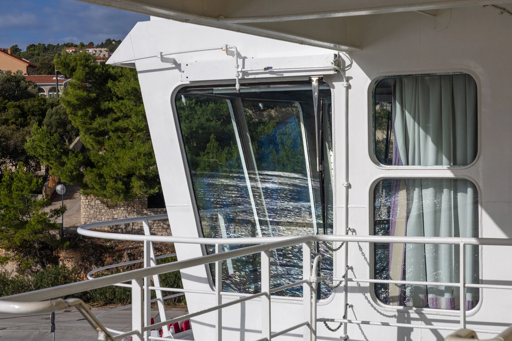 View from a boat deck across calm coastal water